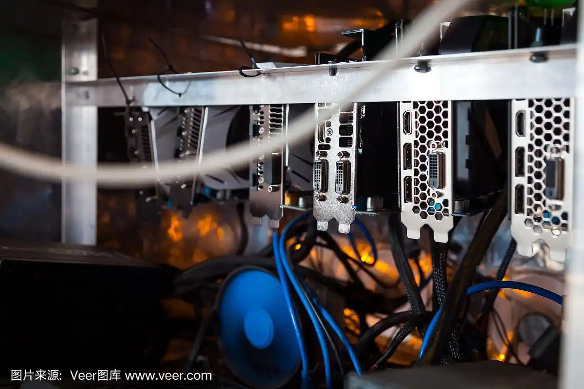 A miner checking the temperature of a GPU on a mining rig.