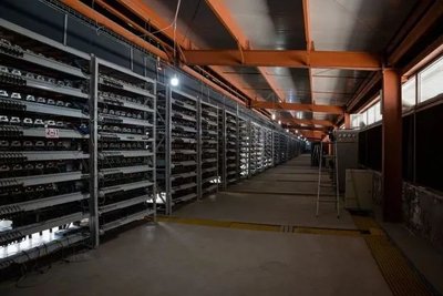 Modern eco-friendly mining farm surrounded by solar panels and wind turbines